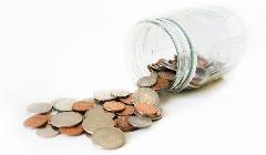 Coins spilling out of a jar