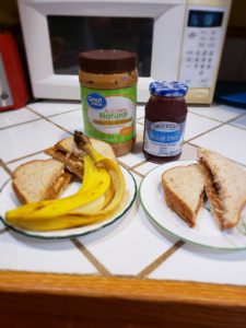 Two different types of peanut butter sandwiches - peanut butter & jelly and peanut butter and banana